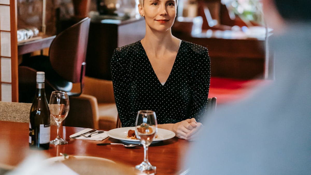 Couple celebrating anniversary at a romantic restaurant dinner with flowers and wine in Orlando