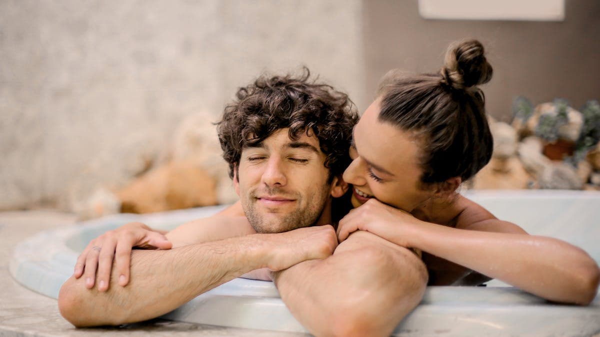 Couple relaxing together in a spa bathtub for a romantic wellness day in Orlando