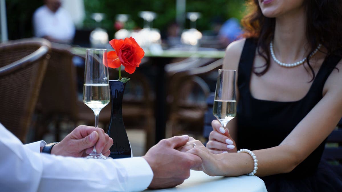 Couple enjoying a romantic dinner date at a restaurant with wine and candlelight