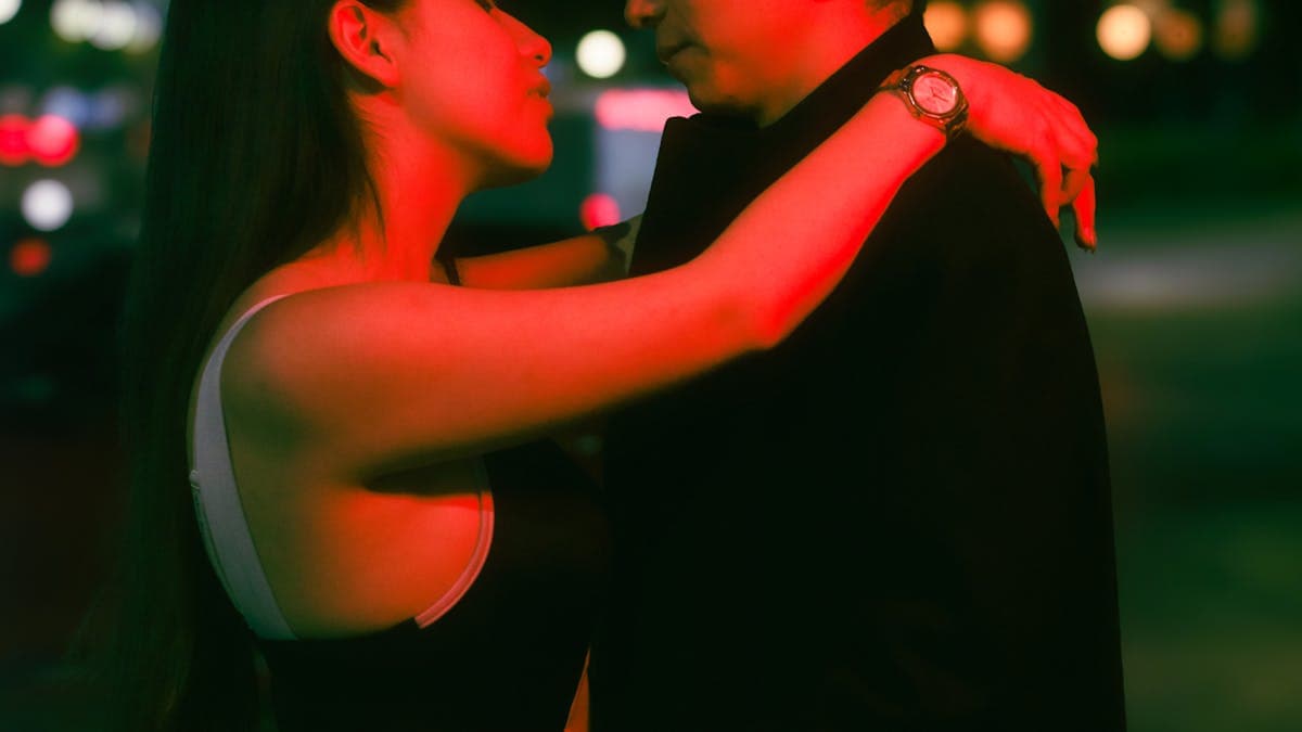 Romantic couple embracing under city lights at night in Orlando
