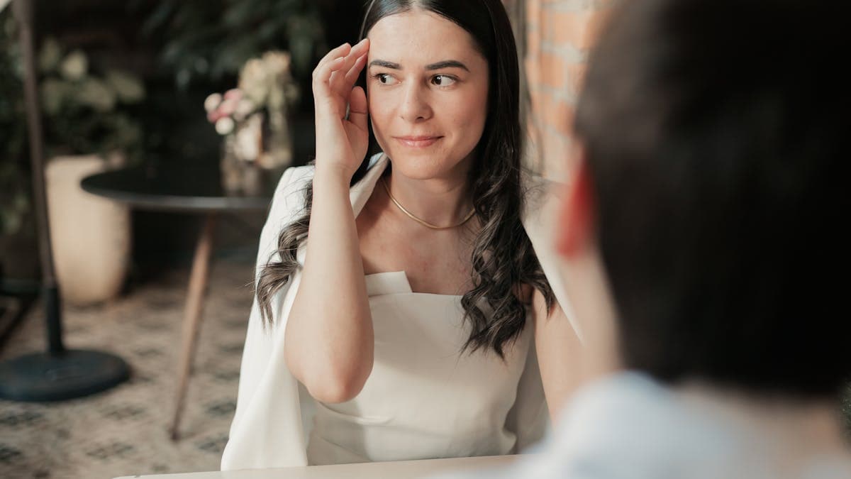 Couple enjoying a romantic dinner date in a cozy cafe on a rainy day