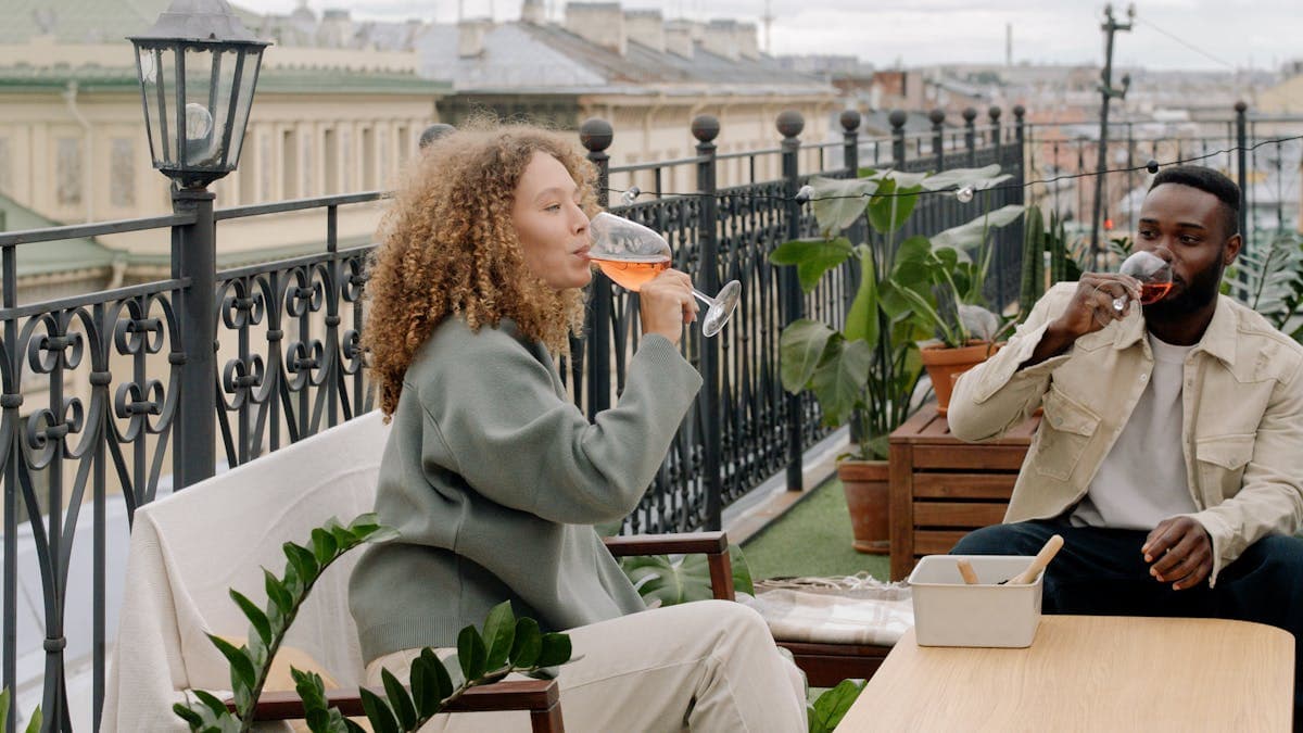 Couple relaxing together on a terrace with drinks at a romantic vacation rental