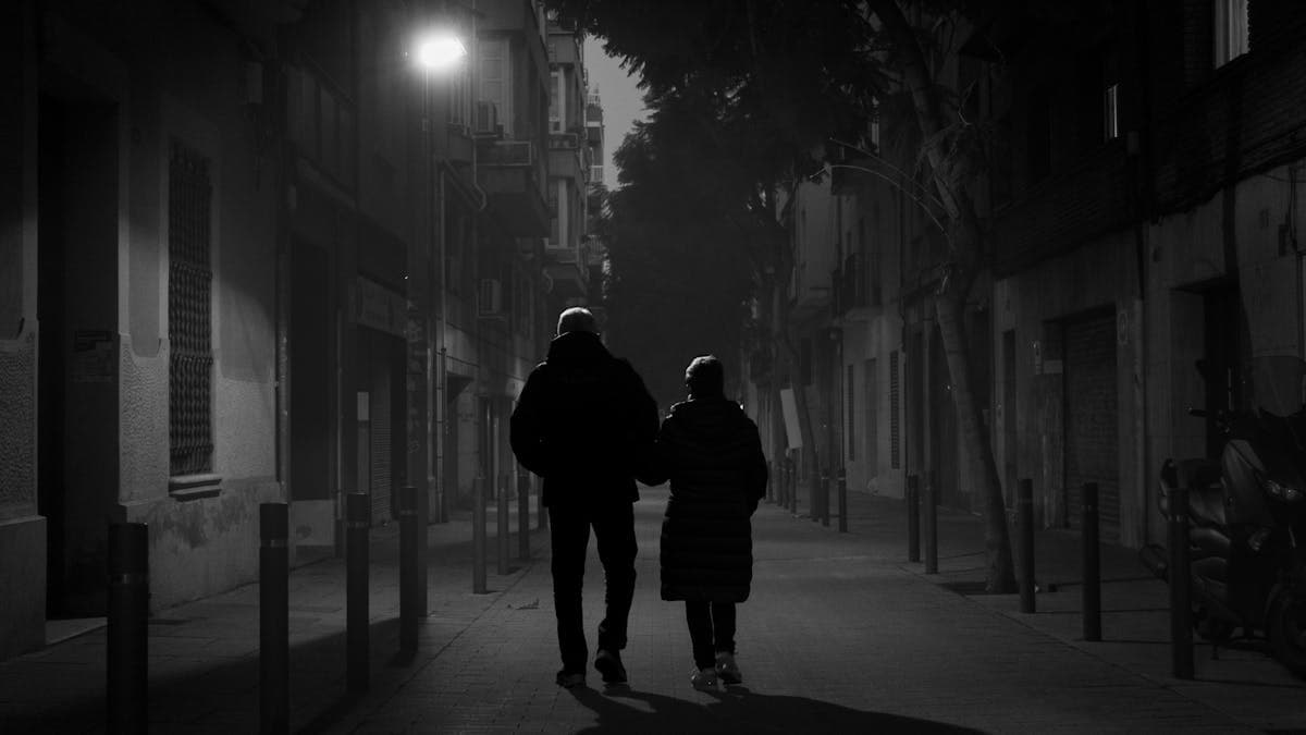 Couple walking together on a city street at night in downtown Orlando