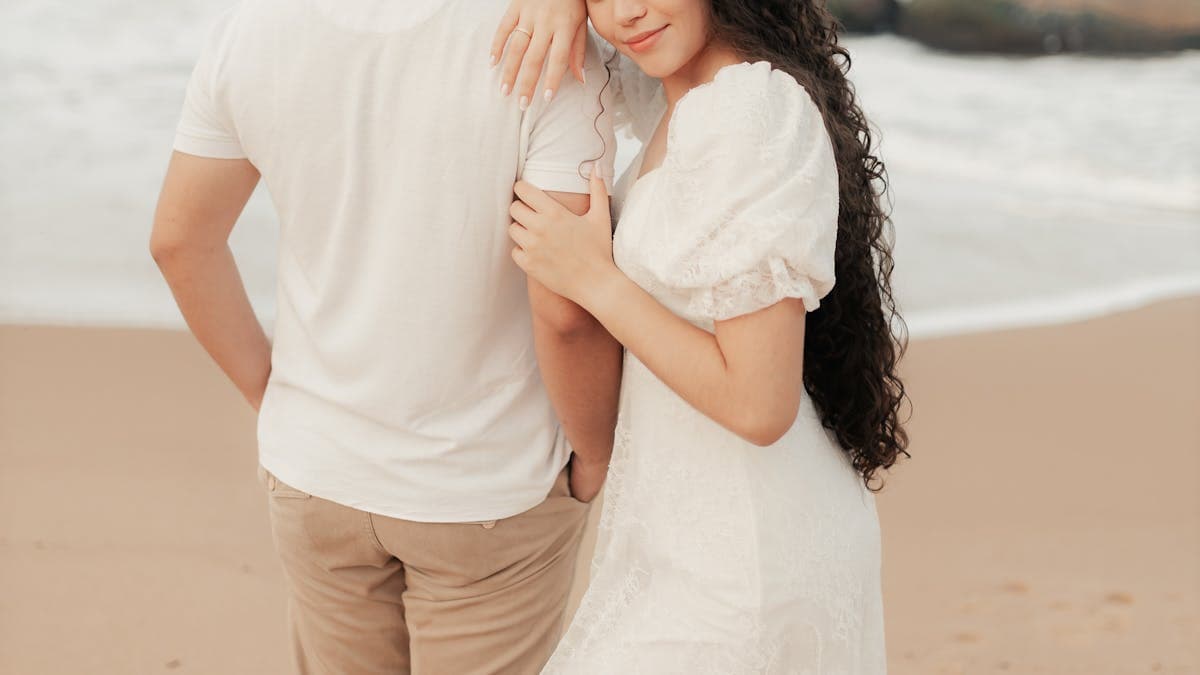 Romantic couple embracing on a Florida beach at sunset during a weekend getaway