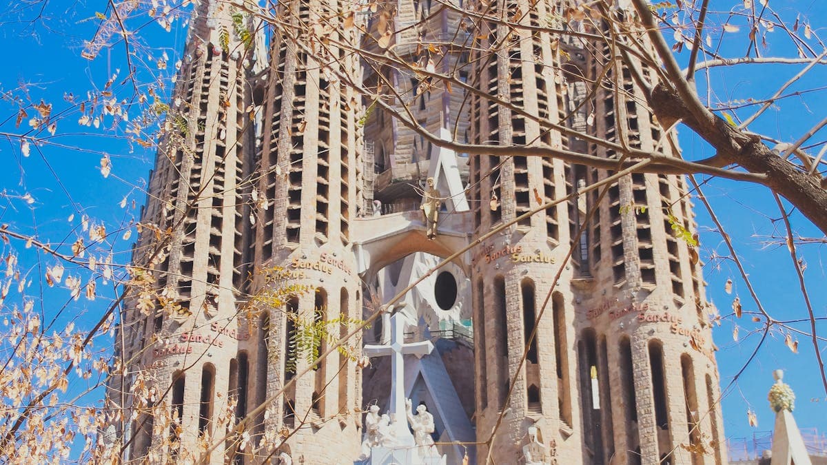 La Sagrada Familia cathedral in Barcelona glowing in golden sunlight, one of the world's most iconic romantic landmarks