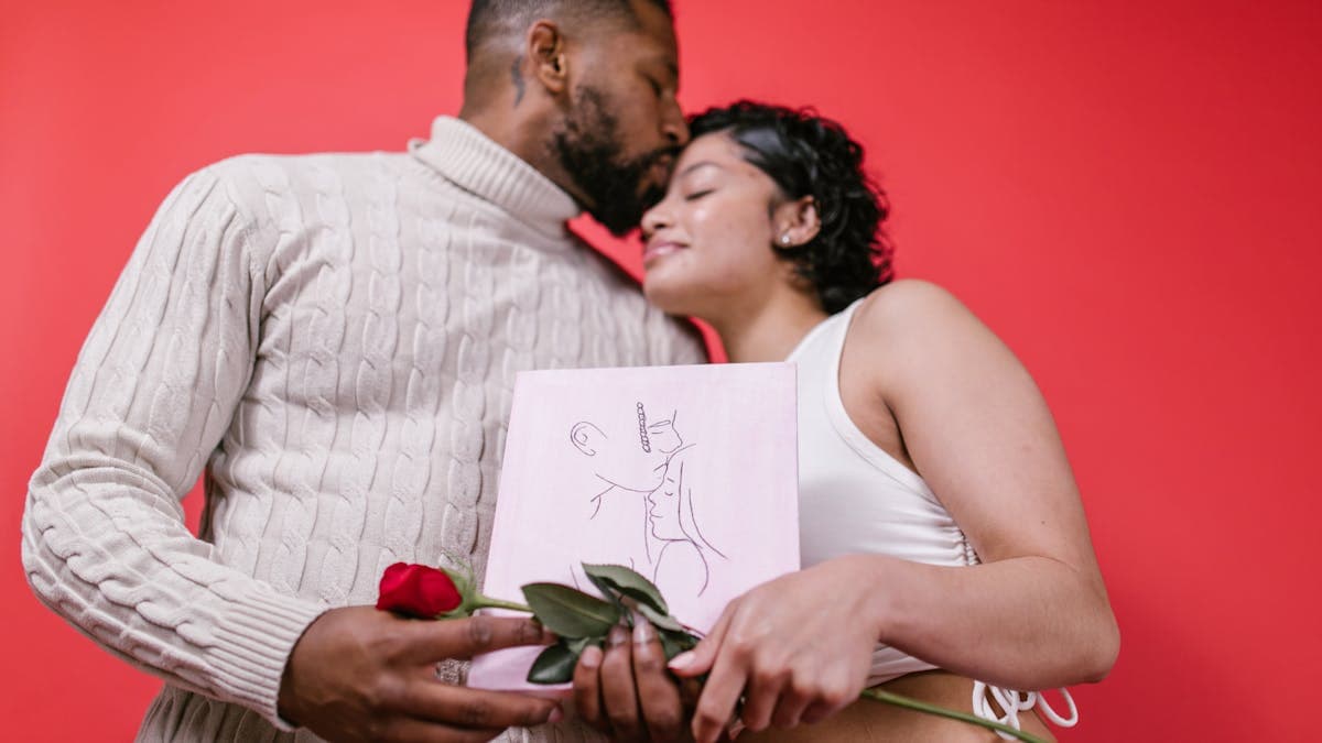 Couple celebrating Valentine's Day with roses and gifts in a romantic setting